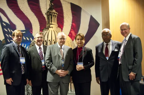 This is an image of Burt Barnow, Chris King, Ray Marshall, Alexis Herman, Ernest Green, and Bob Glover taken at the Ray Marshall Center 40th Anniversary Symposium.  Everyone pictured is wearing business attire and smiling.  