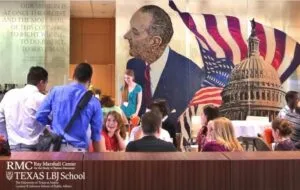 Mural of Lyndon B Johnson at the LBJ School, UT Austin. This is a picture of the Lyndon B Johnson mural at the LBJ School of Public Affairs. There are graduate students sitting and standing during an event.