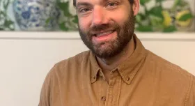 This is an image of David McCoy, a Social Science Research Associate at the Ray Marshall Center at the University of Texas at Austin.  He has a light complexion, dark brown hair and beard, and is smiling.