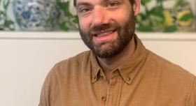This is an image of David McCoy, a Social Science Research Associate at the Ray Marshall Center at the University of Texas at Austin.  He has a light complexion, dark brown hair and beard, and is smiling.