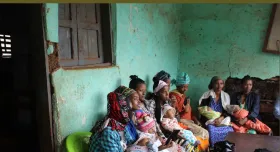 This is the report cover for Nuru Ethiopia 2022 Impact Report.  It shows local women holding babies in a waiting room.