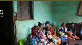 This is the report cover for Nuru Ethiopia 2022 Impact Report.  It shows local women holding babies in a waiting room.