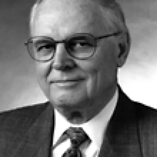 Ray Marshall, PhD This is a black and white picture of Ray Marshall. He has gray hair and is wearing thin-framed glasses. He is wearing a suit and tie.