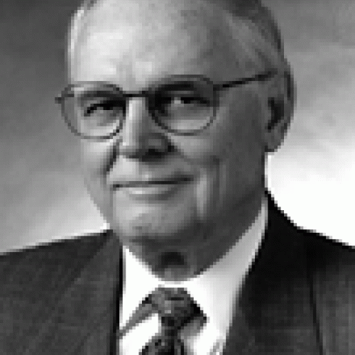 Ray Marshall, PhD This is a black and white picture of Ray Marshall. He has gray hair and is wearing thin-framed glasses. He is wearing a suit and tie.